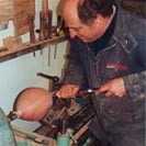 The wooden eggs being turned on a lathe.
